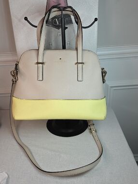 Kate Spade New York Cedar Street Maise satchel in a light beige and yellow color